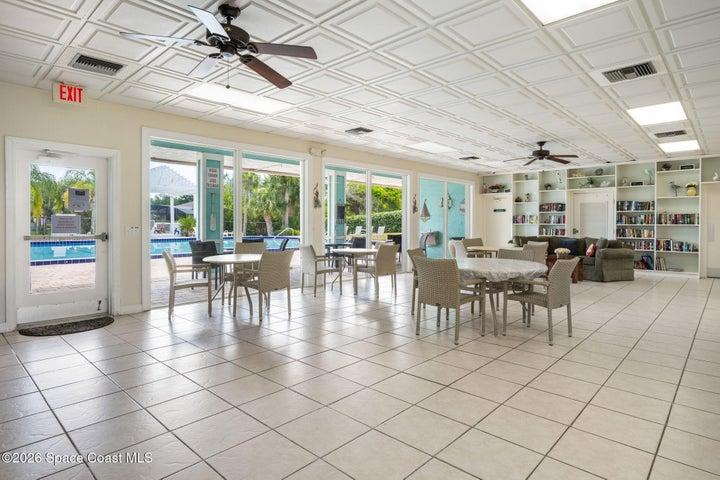 First floor of community room overlooking pool with library space