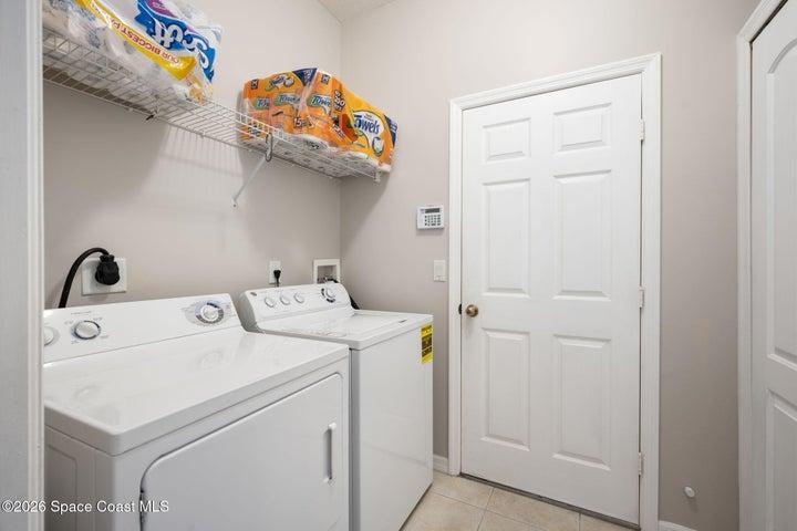 Laundry room featuring washer and dryer with tile flooring