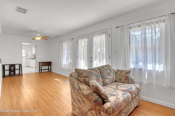 Family room with doors to pool deck.