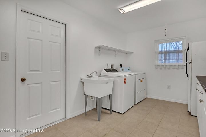 Very large custom laundry room with lots of storage space.
