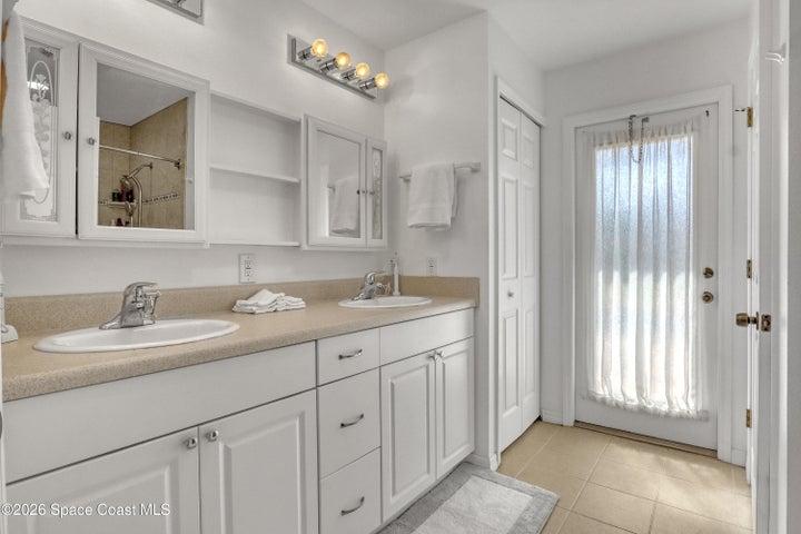 Main bath with door to screened pool deck.