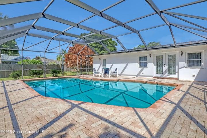 Spacious pool with covered screen.