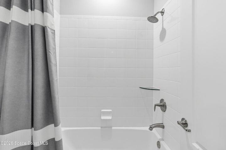 Bathroom 2 shower/tub combination, tile shower wall