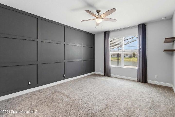 Primary bedroom with accented wall