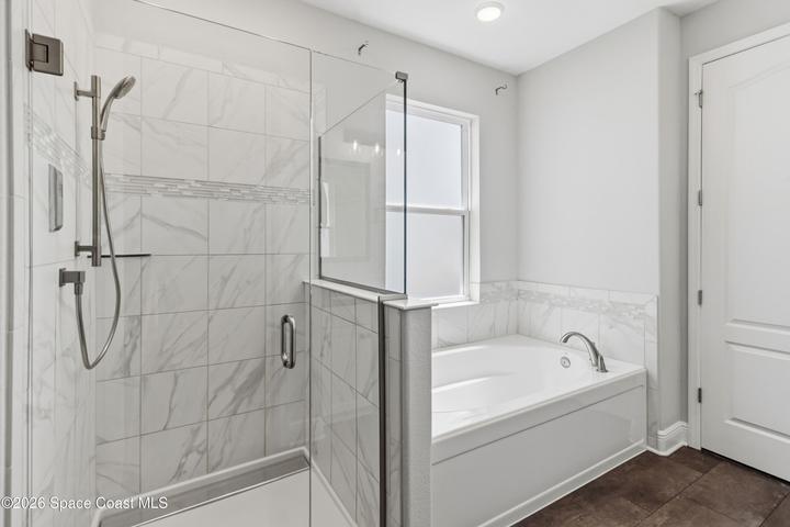 Luxurious shower with programmable control, multi shower head, including a rain shower. Spacious garden tub