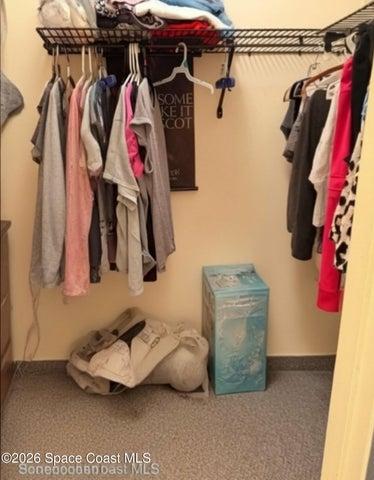 Primary bedroom walk in closet