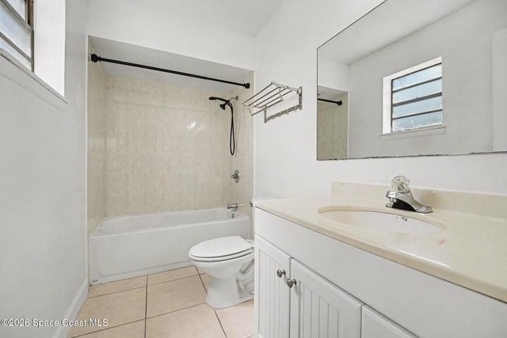 En-Suite Bath Includes Tile Soaking Tub with Shower and Spacious Vanity