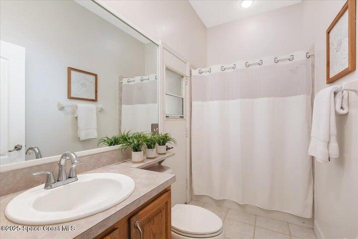 Guest bath leads to the lanai and pool