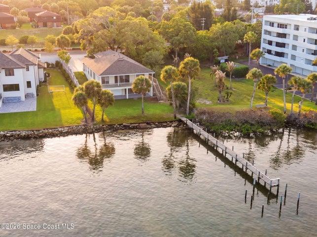 Aerial of back of home and 99' pier / dock