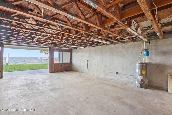 Unfinished 900 SF downstairs -small watercraft garage with roll up door