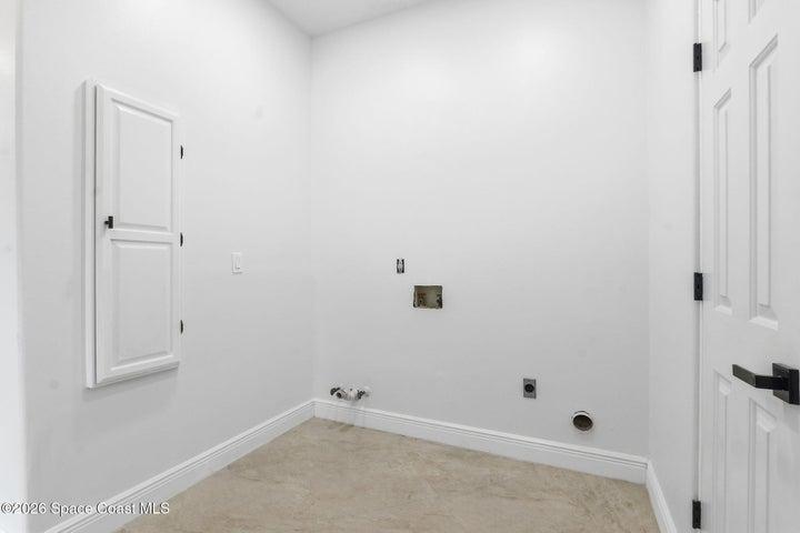 Laundry area on mail level, built in ironing board