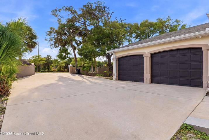 Big driveway - plenty of parking with 2 car garage up and 3rd garage down for water sport toys