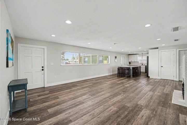 Large living room with view of kitchen.
