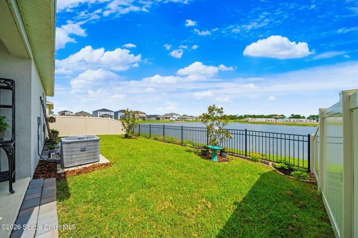 Fenced in backyard with lake views