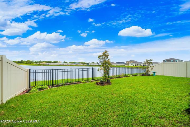 Fenced in backyard with lake views