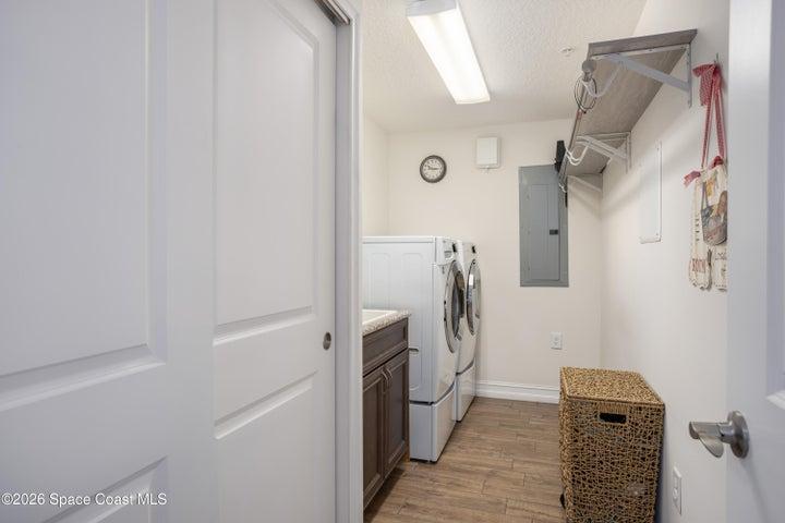 Spacious laundry room to include large utility sink and laundry drying rack.