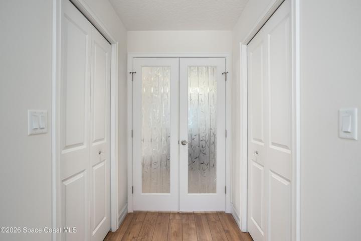His and her walk in closets. Safe. Elegant glass french doors leading to the luxurious primary bath.