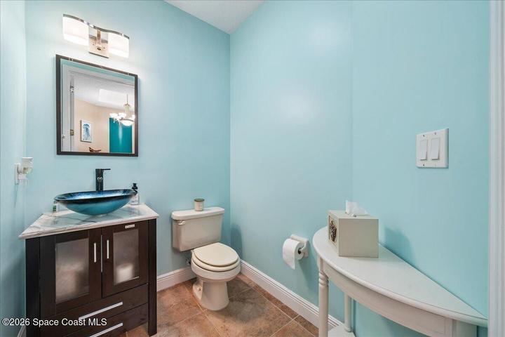 Half bath with vessel sink abuts the indoor laundry area (see floorplan).