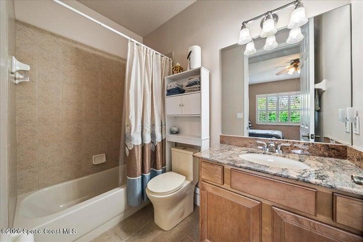 Ensuite Bath #2, hardwood cabinetry, beautiful lighting and fit for your most special guests.