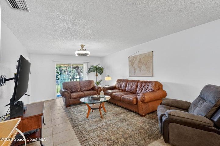 Living area w/sliders leading to a private screened patio.
