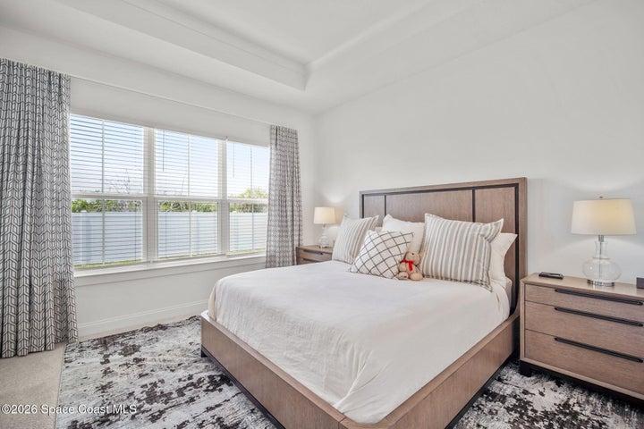 Primary bedroom with custom window treatments