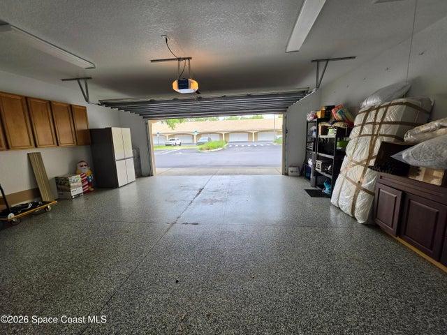 Oversized 2 car garage is loaded with storage space, attic and floors with epoxy finish. Unusual condo amenity is a 2+ car garage.