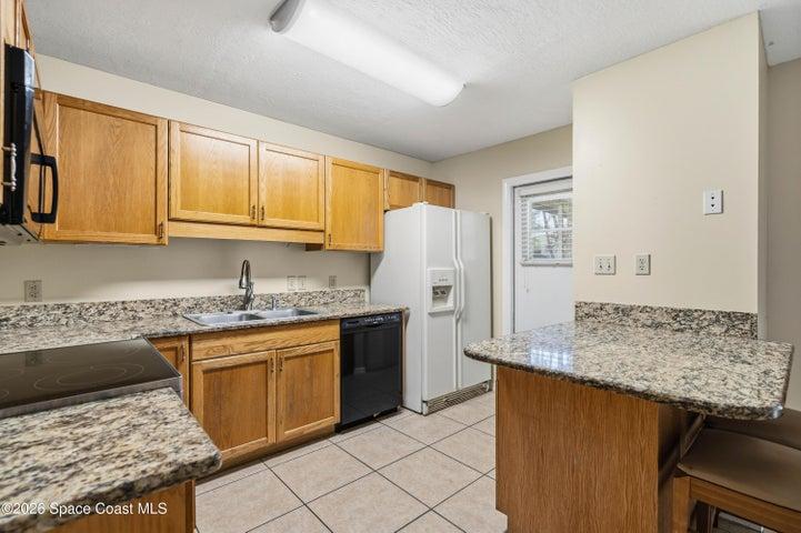 Kitchen with door leading to patio.