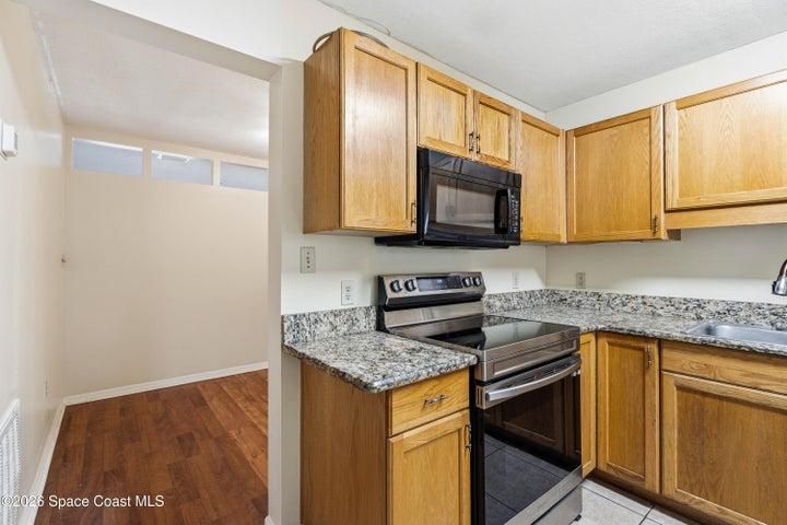 Kitchen and bonus room behind it.