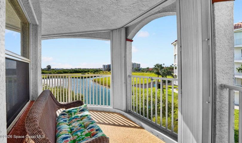 Covered balcony offering a relaxing, peaceful atmosphere...an ideal space to unwind and enjoy quiet moments outdoors.