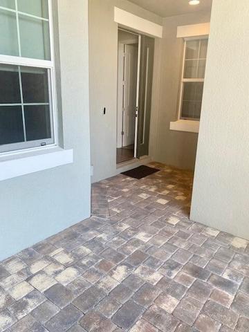 SCREENED AND COVERED FRONT PORCH WITH PAVERS