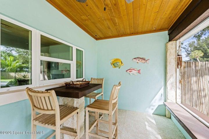 Impact pass-thru window with built in concrete table, all with coralina stone accents - Enjoy the FL outdoors