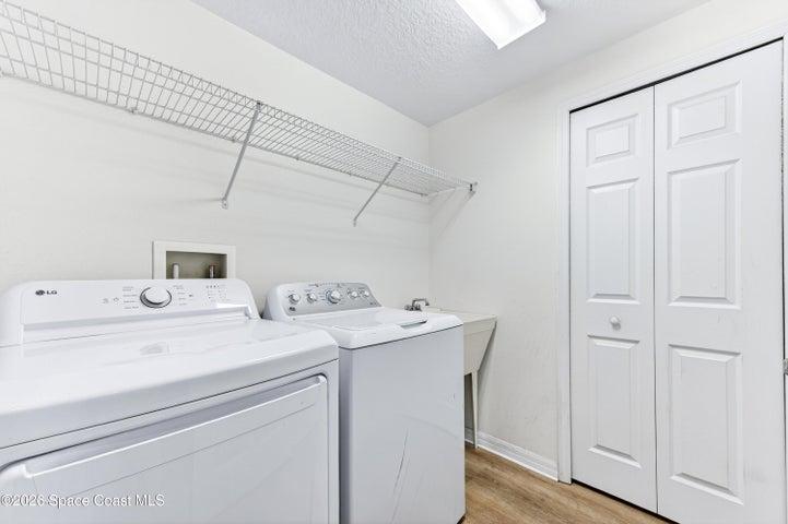 Utility/laundry room with AC handler closet on right