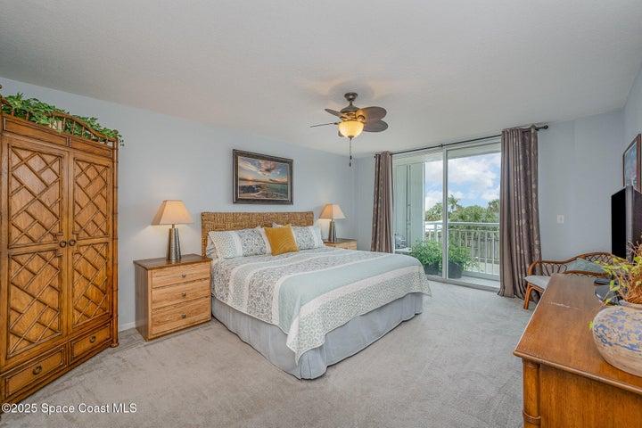 Spacious Primary Bedroom with Walk-in Dual Closets, Slider to Balcony, & En-Suite Bathroom with Dual Sinks, Walk-In Shower, & Separate Soaking Tub.