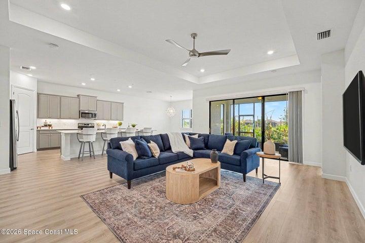 Large living room that opens up to screened in patio lanai