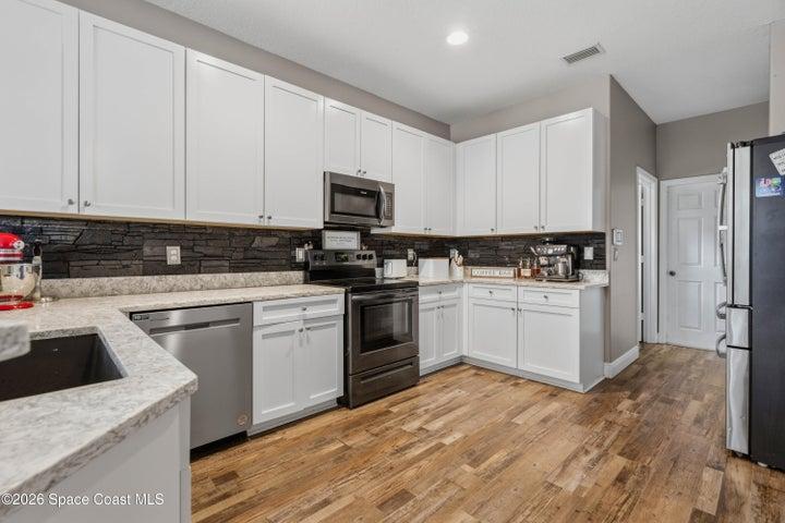 Kitchen with laundry room and garage access shown in the rear