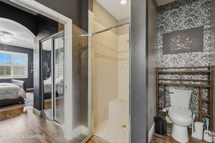 Primary ensuite shower and toilet area.