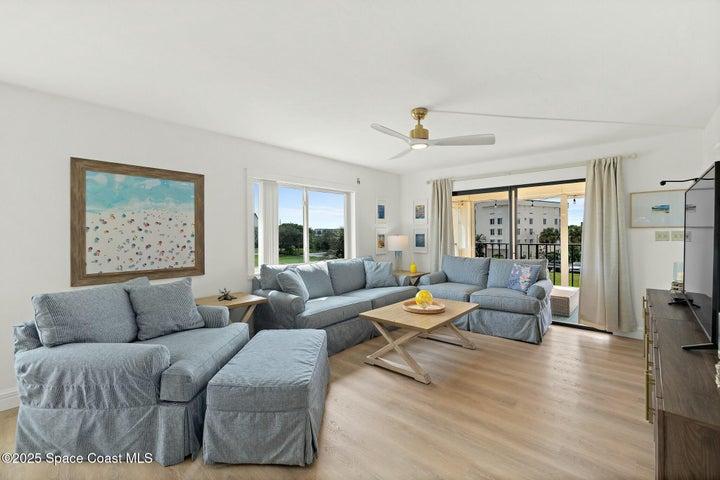 Living room with sliding glass doors to balcony, direct pond view, Riverwest, Cocoa Beach