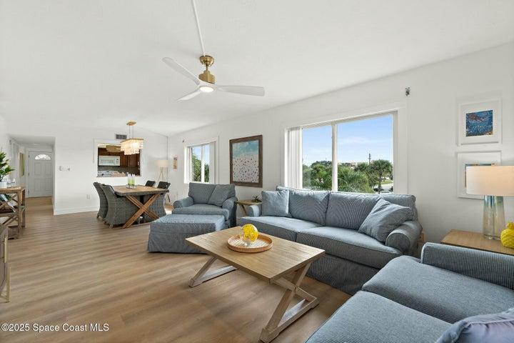 Living room with picture windows overlooking Riverwest grounds, view toward Atlantic Ocean, Cocoa Beach