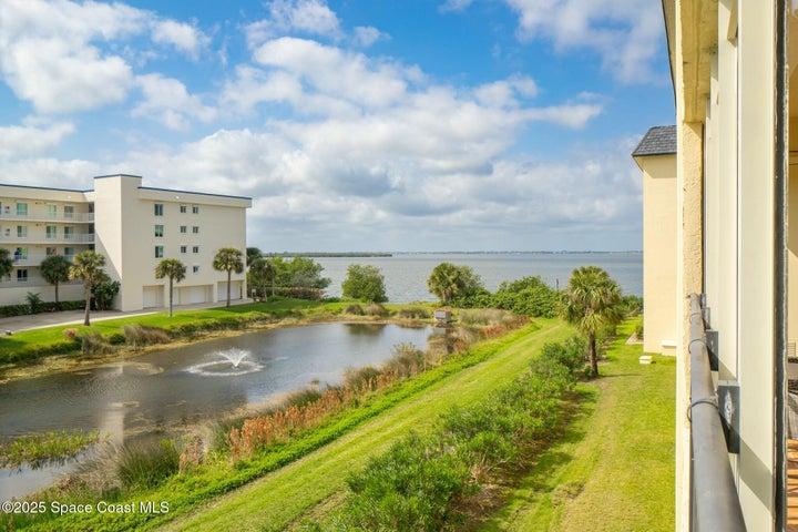 Aerial river-facing view from Riverwest condo balcony showing pond and Banana River, Cocoa Beach, Florida