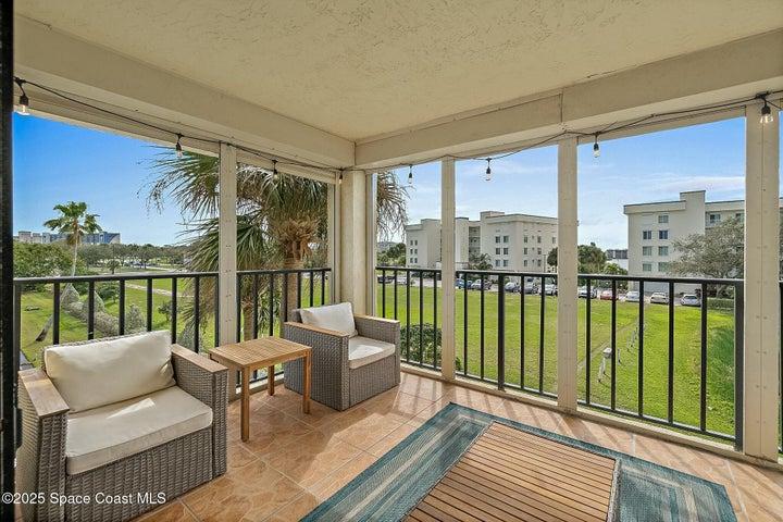 Balcony with seating area and direct pond view, Riverwest condo, Cocoa Beach, Florida