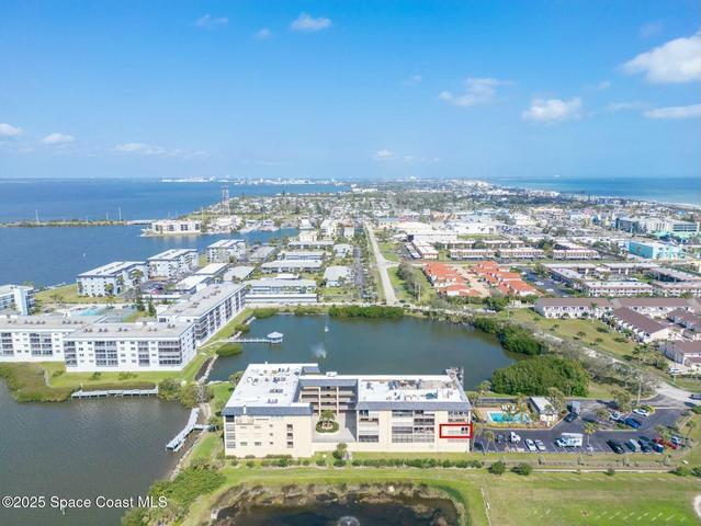 Aerial view highlighting the 3rd-floor unit at Riverwest condo, Banana River and Atlantic Ocean views, Cocoa Beach, Florida
