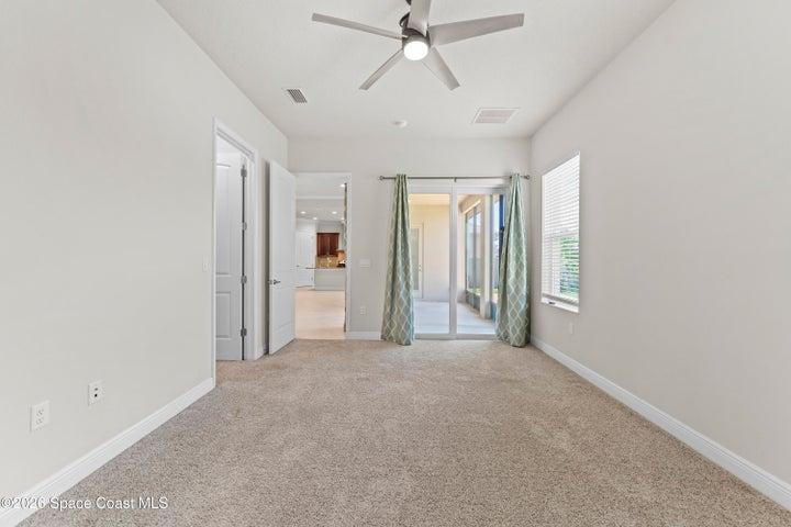 Large primary bedroom has access to screened porch