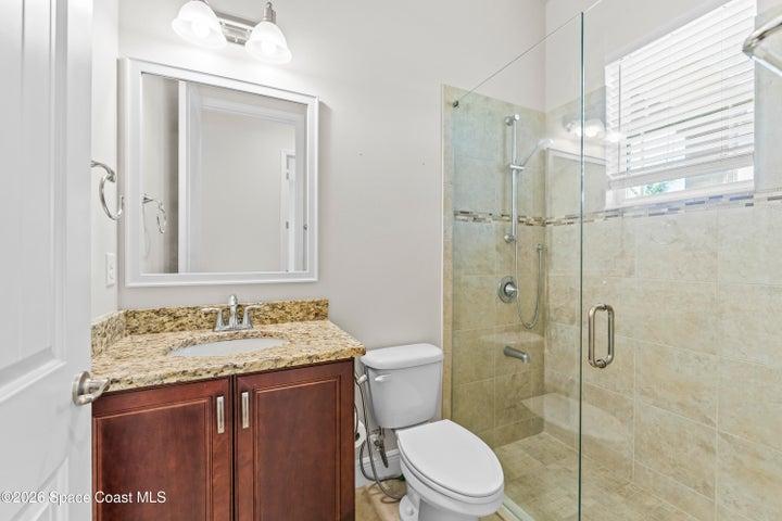 3rd full bathroom in hallway with 2 more bedrooms
