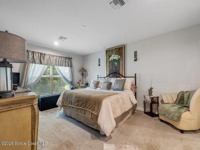 Spacious room featuring light gray walls and plush carpeting