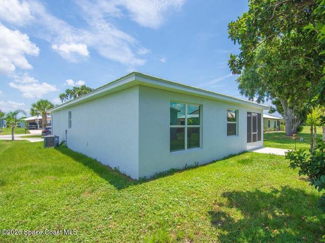 Expansive green lawn with mature trees and established landscaping