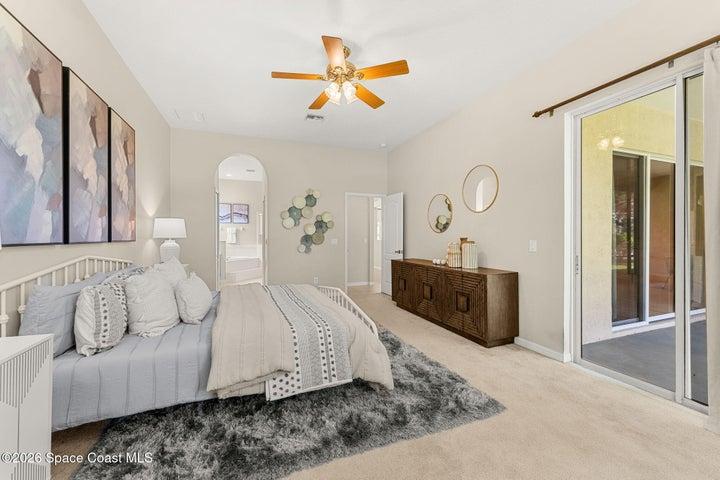 Primary Bedroom with view of ensuite and slider to screened in lanai