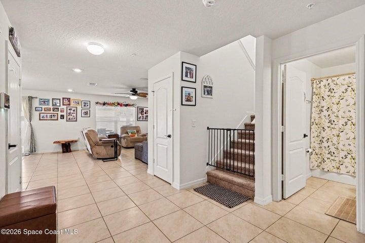 Large entry to 5th bedroom/office, 3rd bathroom and stairs