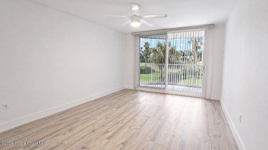 Digitally edited image showcasing the spacious primary bedroom with furniture removed.