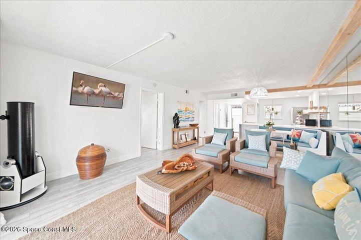 Unwind in the bright, open living room, where a telescope offers the perfect opportunity to enjoy the Space Coast's spectacular rocket launches and evening stargazing.