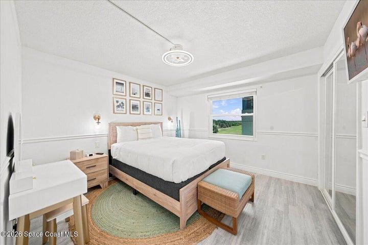 Bright and inviting guest bedroom featuring modern coastal finishes, abundant natural light, and generous closet space, creating a comfortable retreat for family and guests.